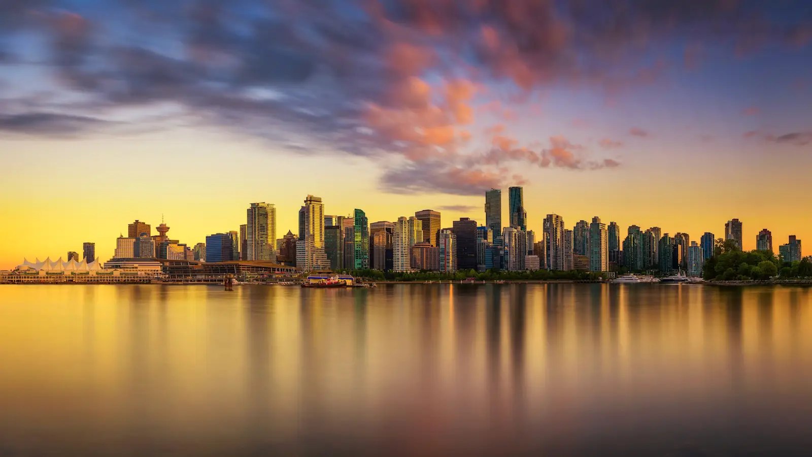 Downtown skyline and Canada Place seen across Coal Harbour at sunset