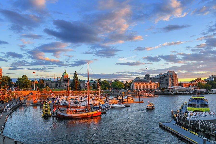 Boats in Victoria's Inner Harbour below the Parliament Buildings at sunset